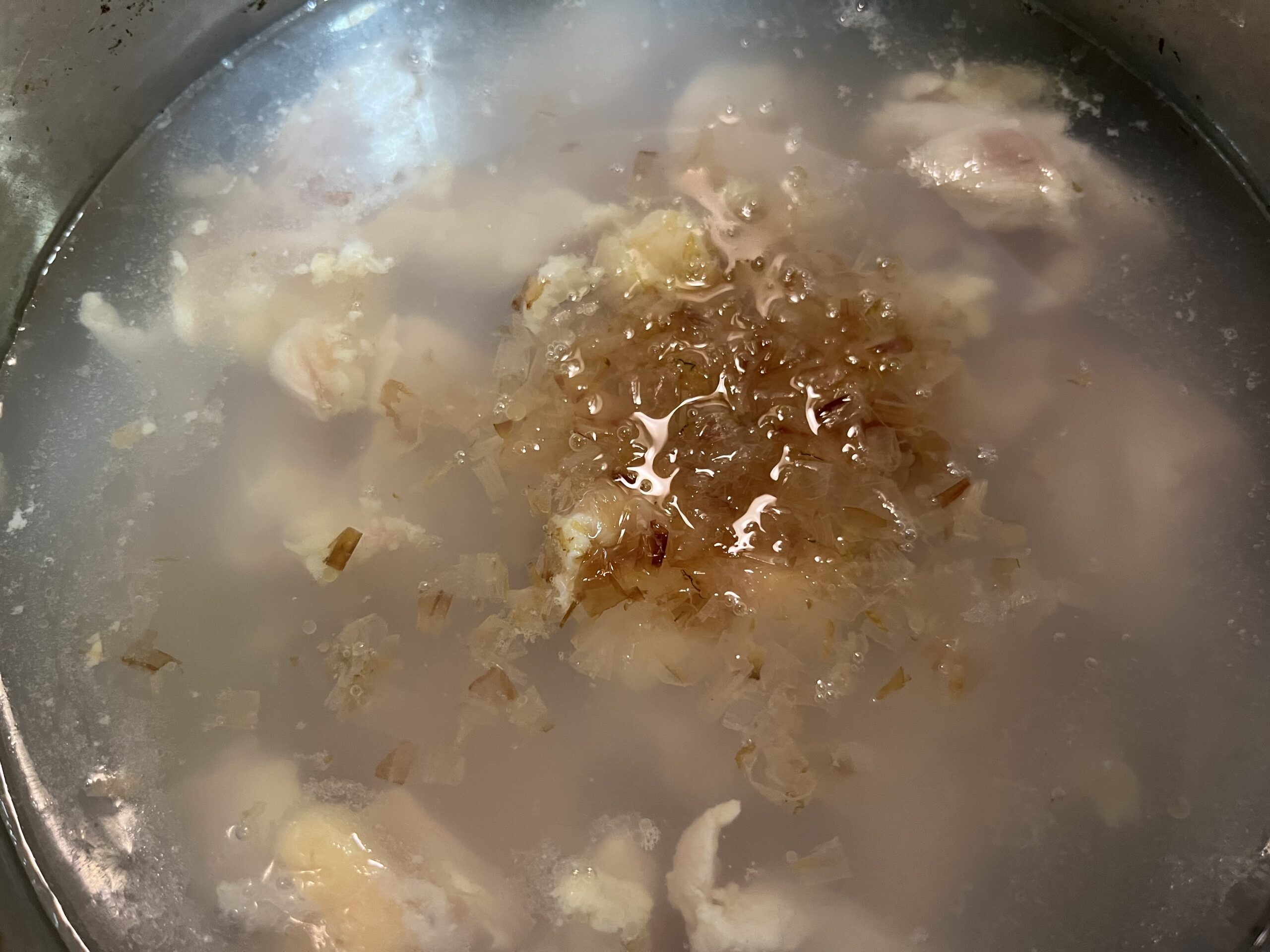 鶏モモ肉とかつお節を鍋で煮込む様子を撮影した写真